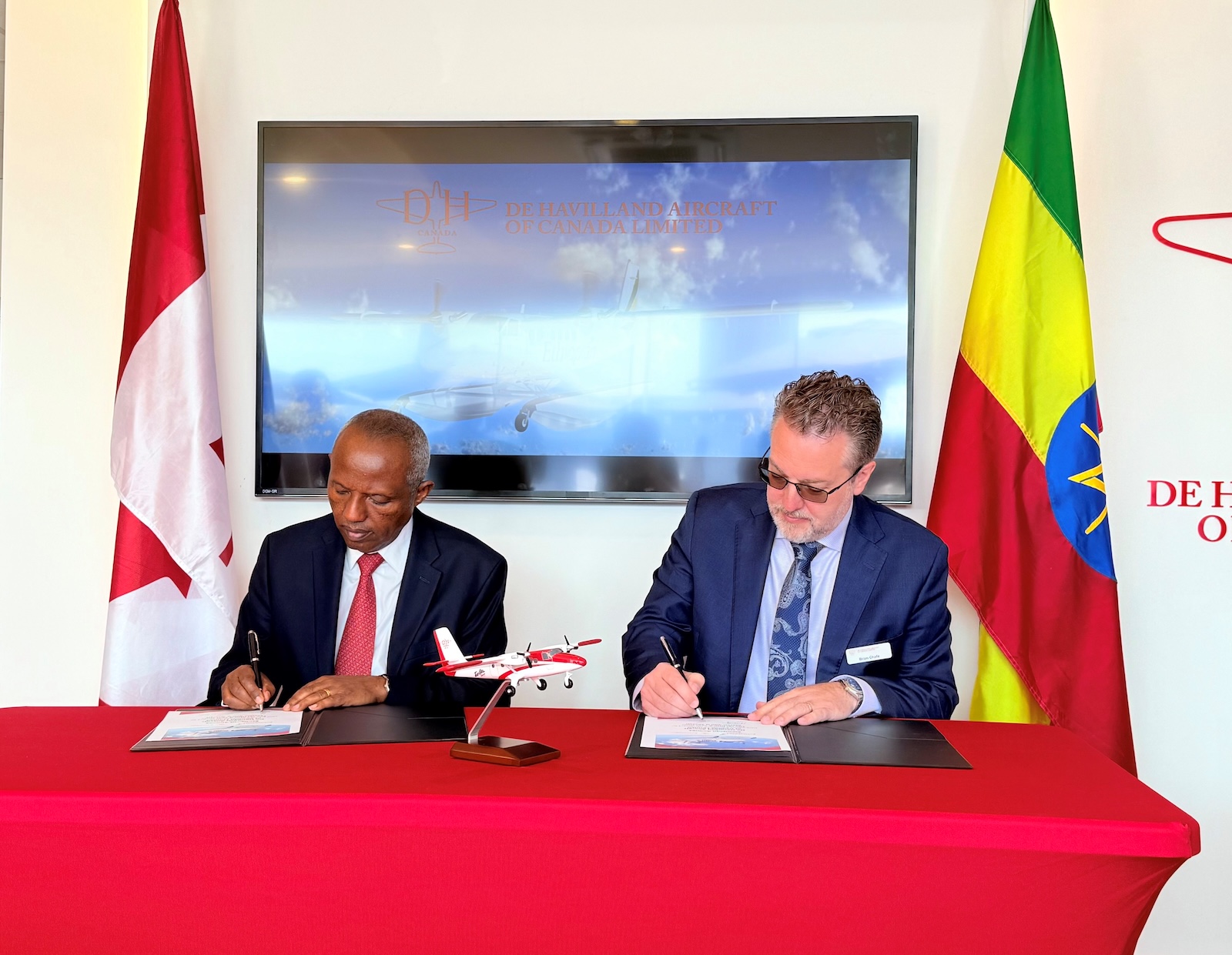 Ethiopian Airlines executives sign deal for new Twin Otter aircraft.