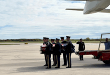 A military honor guard carries Pfc. Dulyea's casket