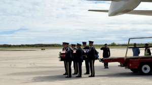 A military honor guard carries Pfc. Dulyea's casket