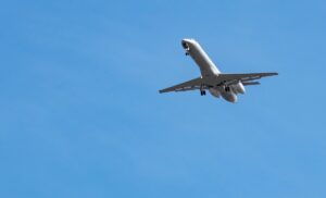 Underside view of Embraer ERJ-145 airplane with landing gear out as it approaches airport for landing