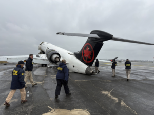 NTSB investigators walk the scene of the March 22 collision between an Air Canada Express plane and a firefighting vehicle on Runway 4 at LaGuardia Airport.