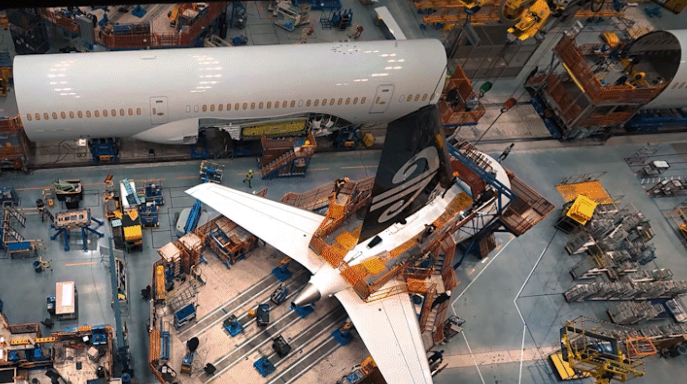 Sections of the enhanced 787-9 are loaded into Final Assembly